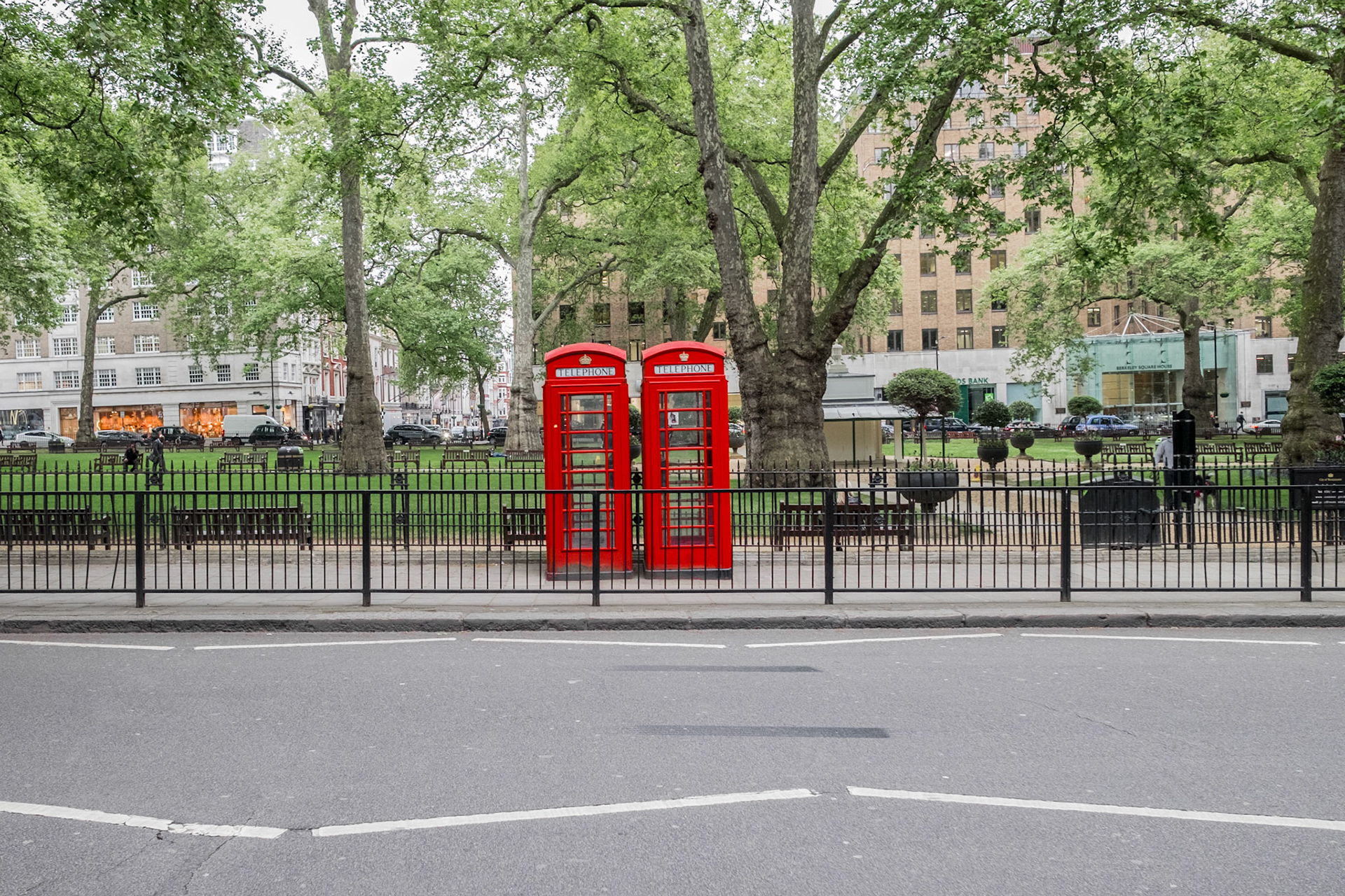 Red gaudy telephone booth near Green Park Station in London.