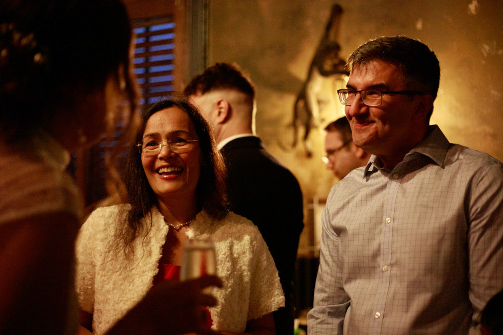 Wedding guests smiling at something Gemma said