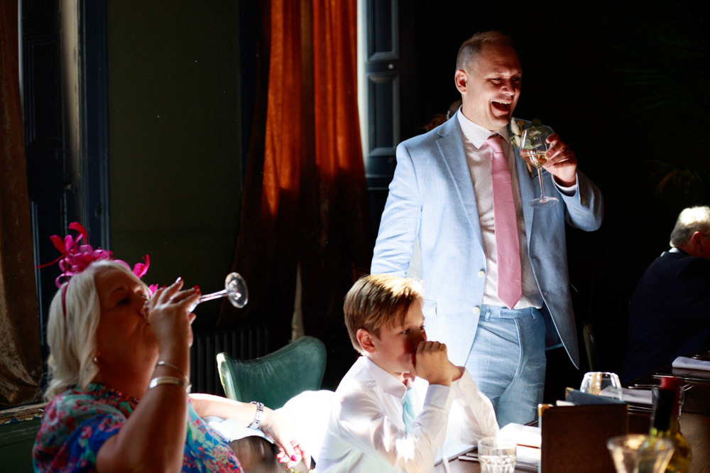 Wedding guests seated upstairs enjoying drinks before the meal