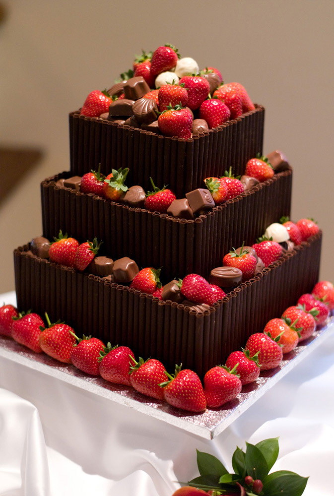 Chocolate wedding cake with strawberries and chocolate decorations