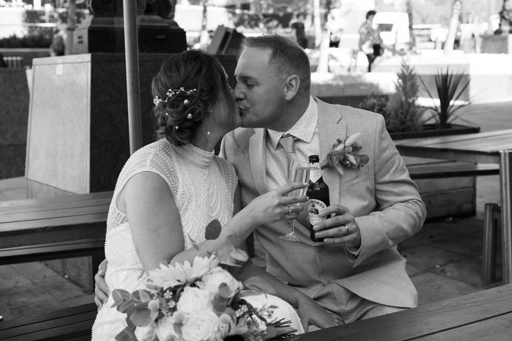 Bride and groom kiss in black and white before heading to Leeds reception