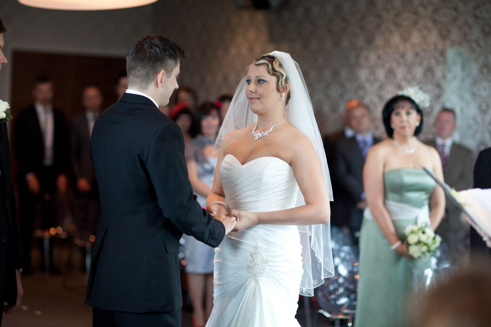 The couple’s hands as they exchange vows.