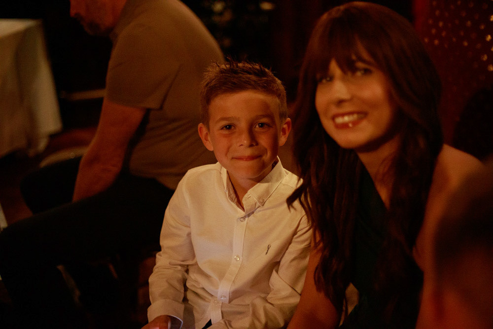 Groom’s sister poses proudly with her young son