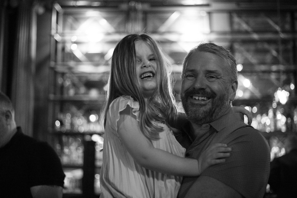 A father and daughter smiling brightly for the camera