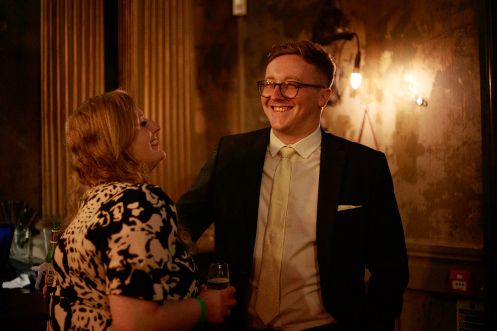 Guests smiling at the camera during the evening reception