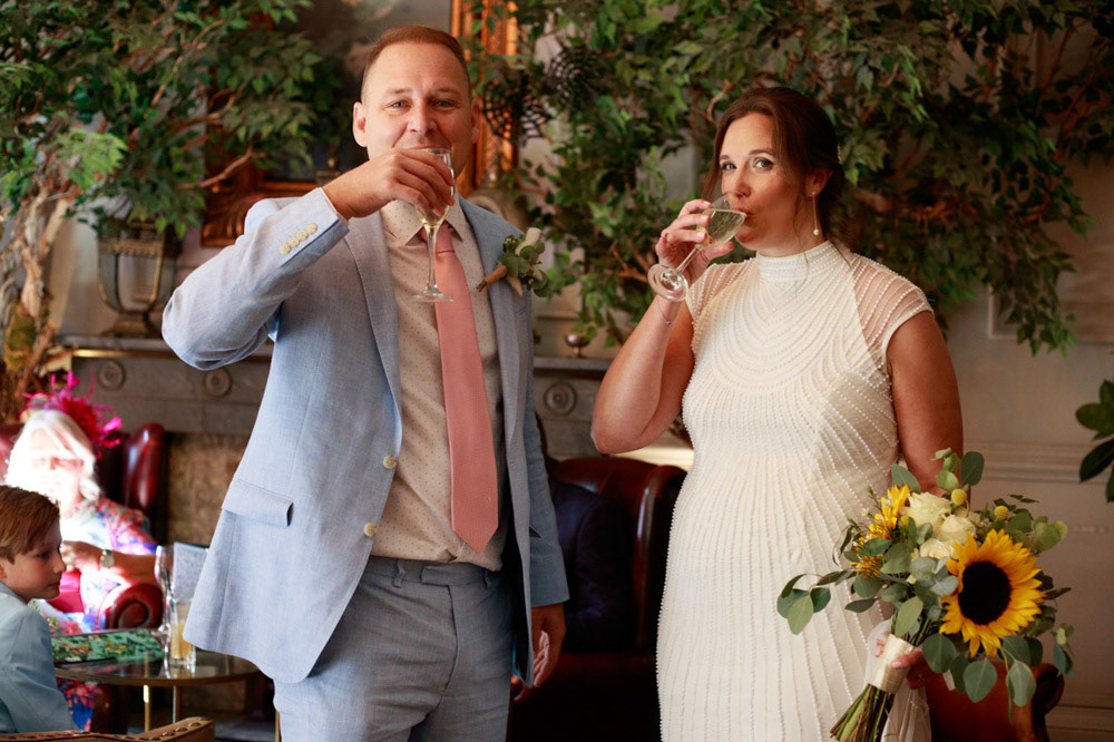 Gemma and Danny share a champagne toast with smiles