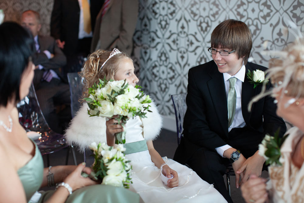 The little bridesmaid becomes the centre of attention with family.