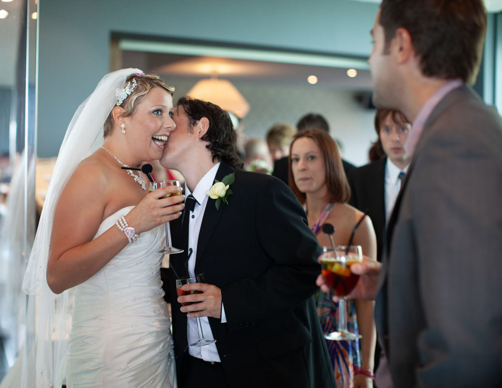Sam receives a joyful kiss on the cheek from a friend after the ceremony.