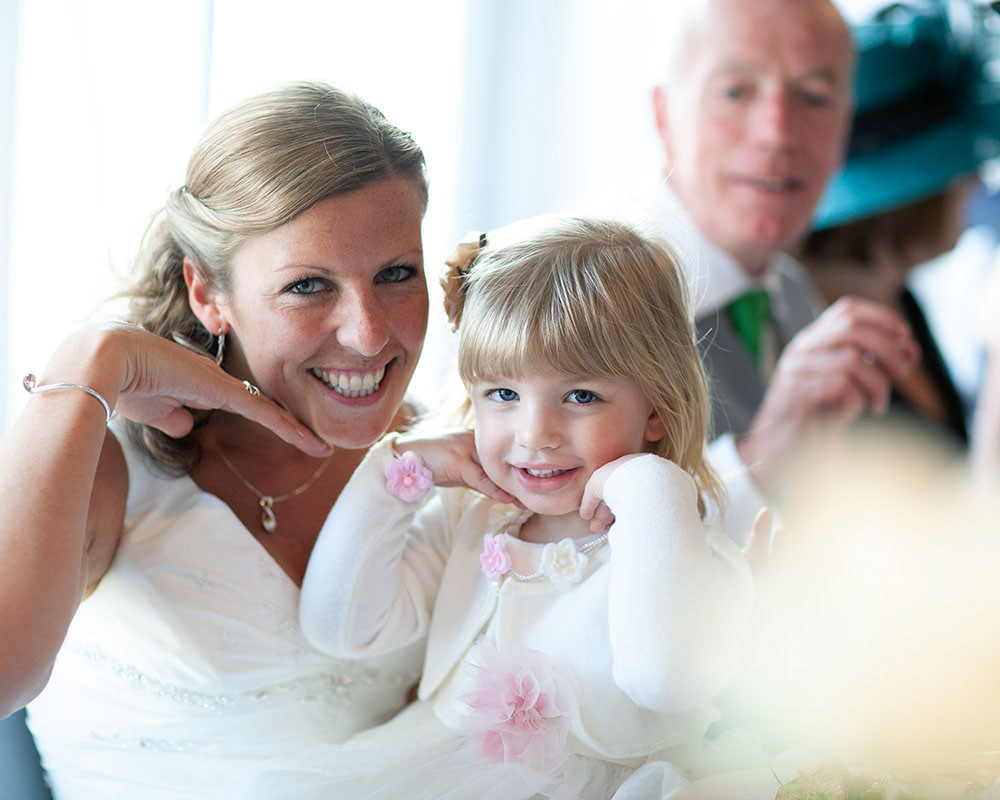 Bride and daughter sharing a playful pose during the wedding breakfast — natural moment at a Leeds wedding celebration.