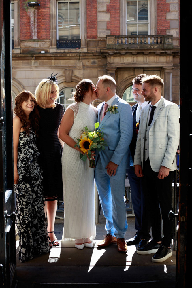 Family group photo on the steps of Lost & Found Leeds