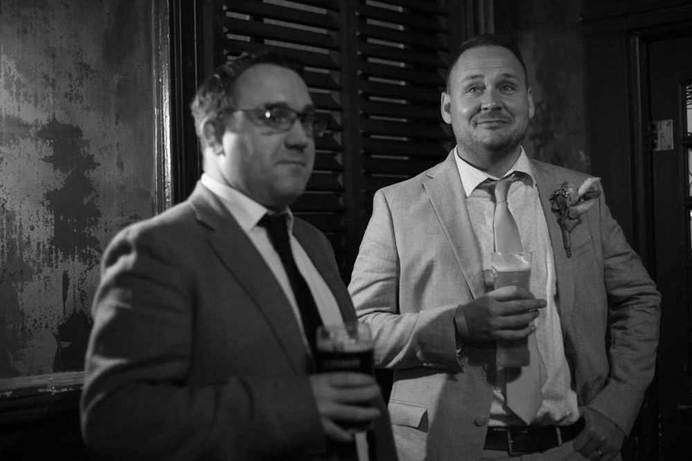 Groom stood by his best man drinking looking happy at the Lost & Found Leeds Club wedding reception