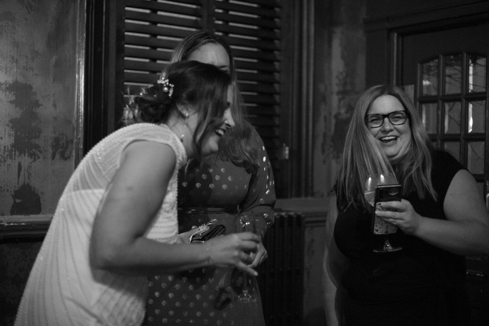 Gemma laughs with friends during the evening reception