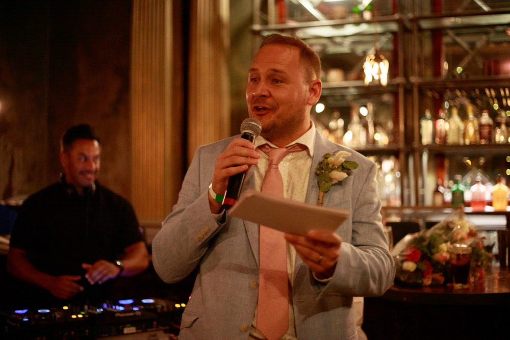 Groom begins his wedding speech to smiling guests
