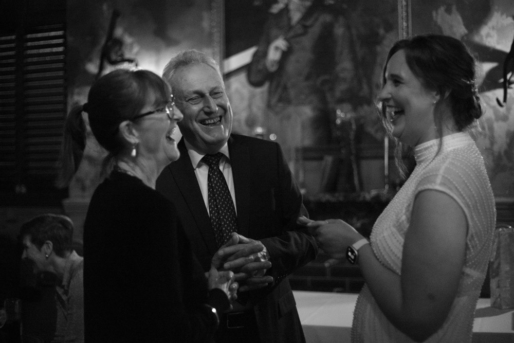 Gemma laughing with arriving guests during the reception