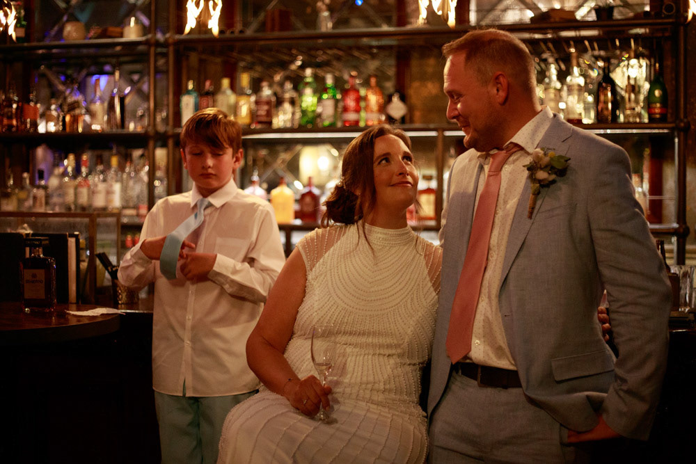 Bride and groom smiling at each other during the speech