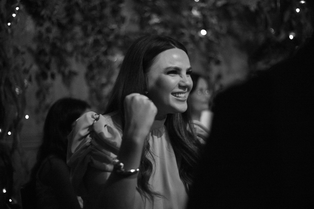 Female guest cheers with a playful fist pump
