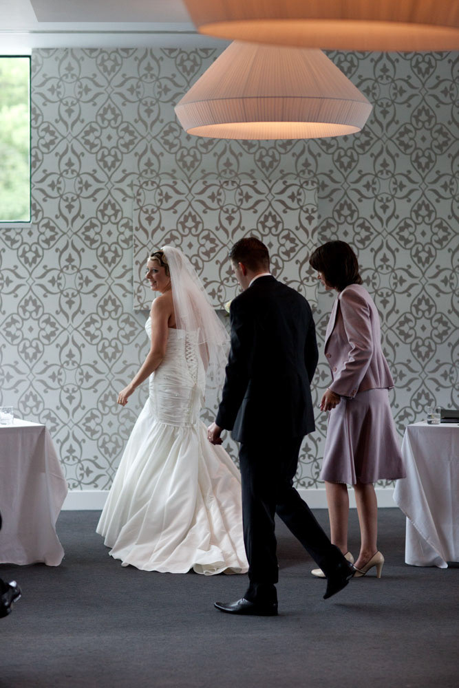 The couple walk together towards the register signing table.