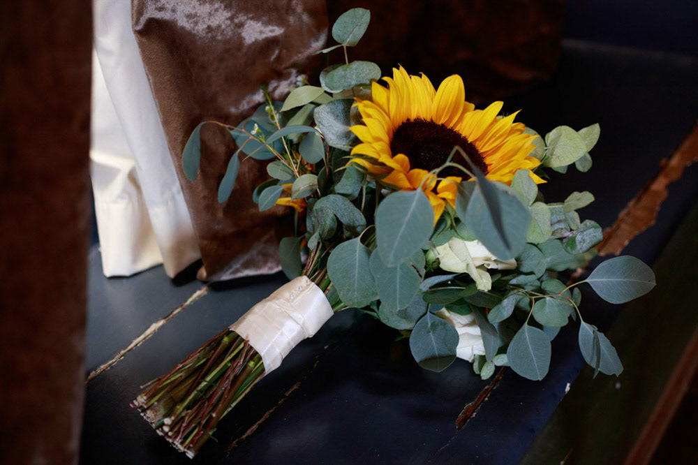 Sunflower wedding bouquet by the curtain in soft window light