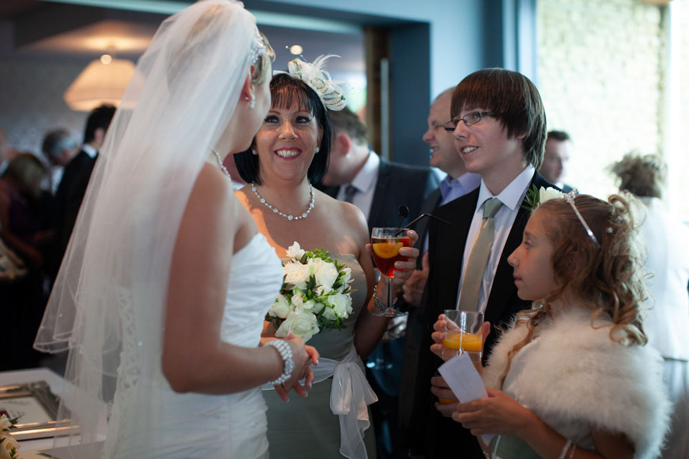 More guests gather around Sam as she exits, smiles all around.