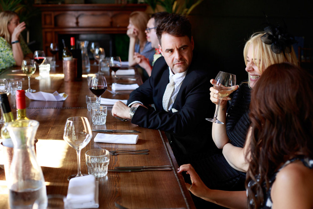 Guests laughing around the wedding breakfast table at Lost & Found Leeds