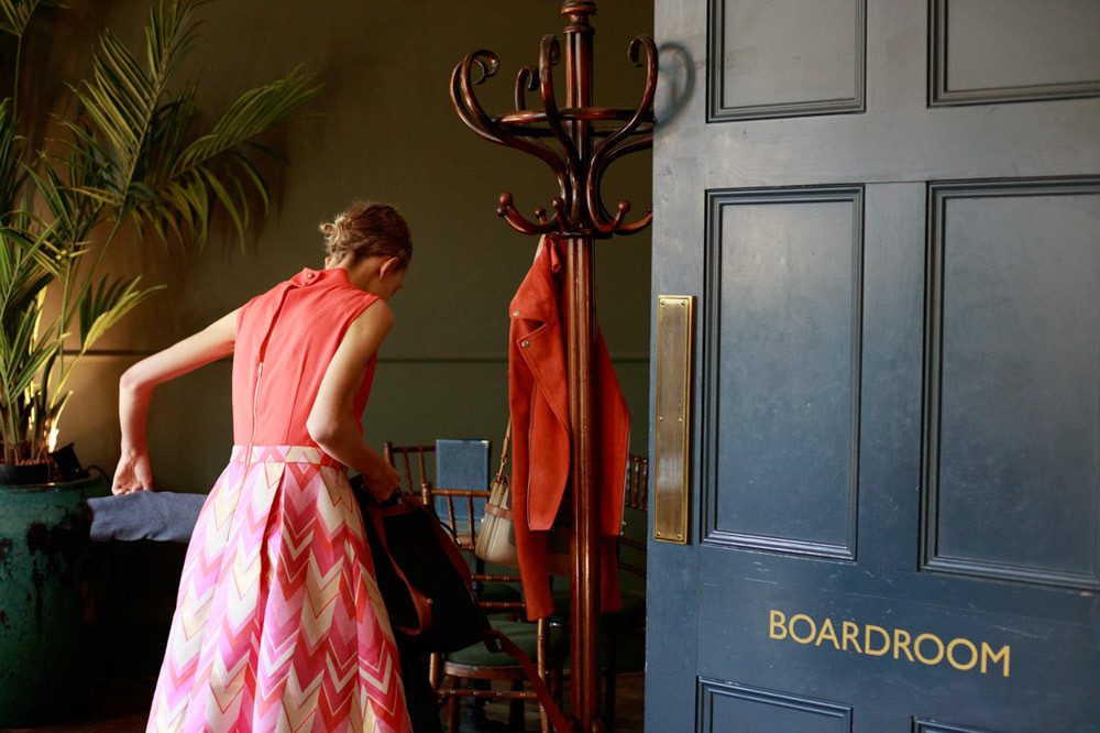 Bride's close friend leaves the boardroom with a soft smile