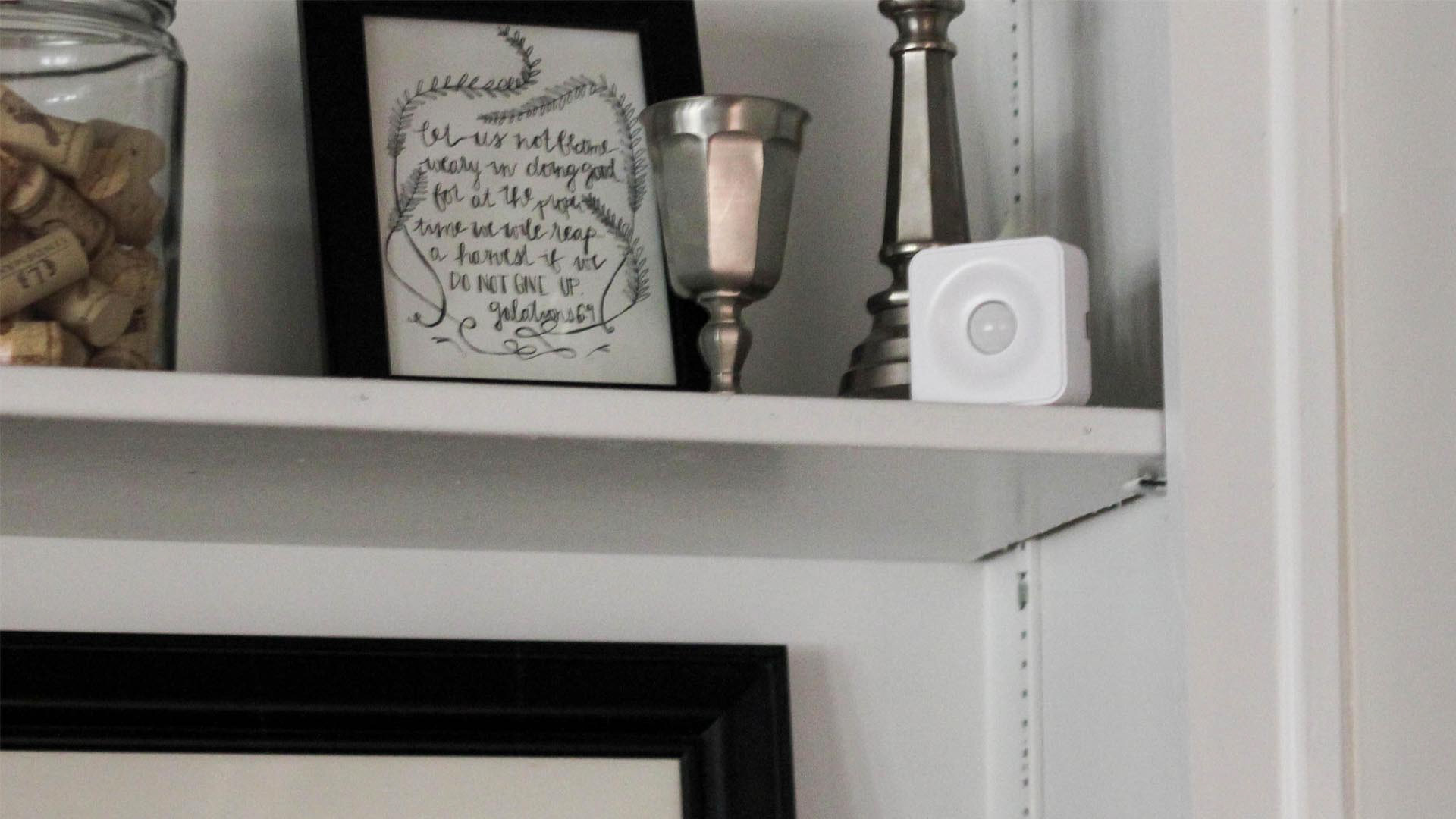 PEQ home security sensors featuring a photo of the motion sensor in a home setting.