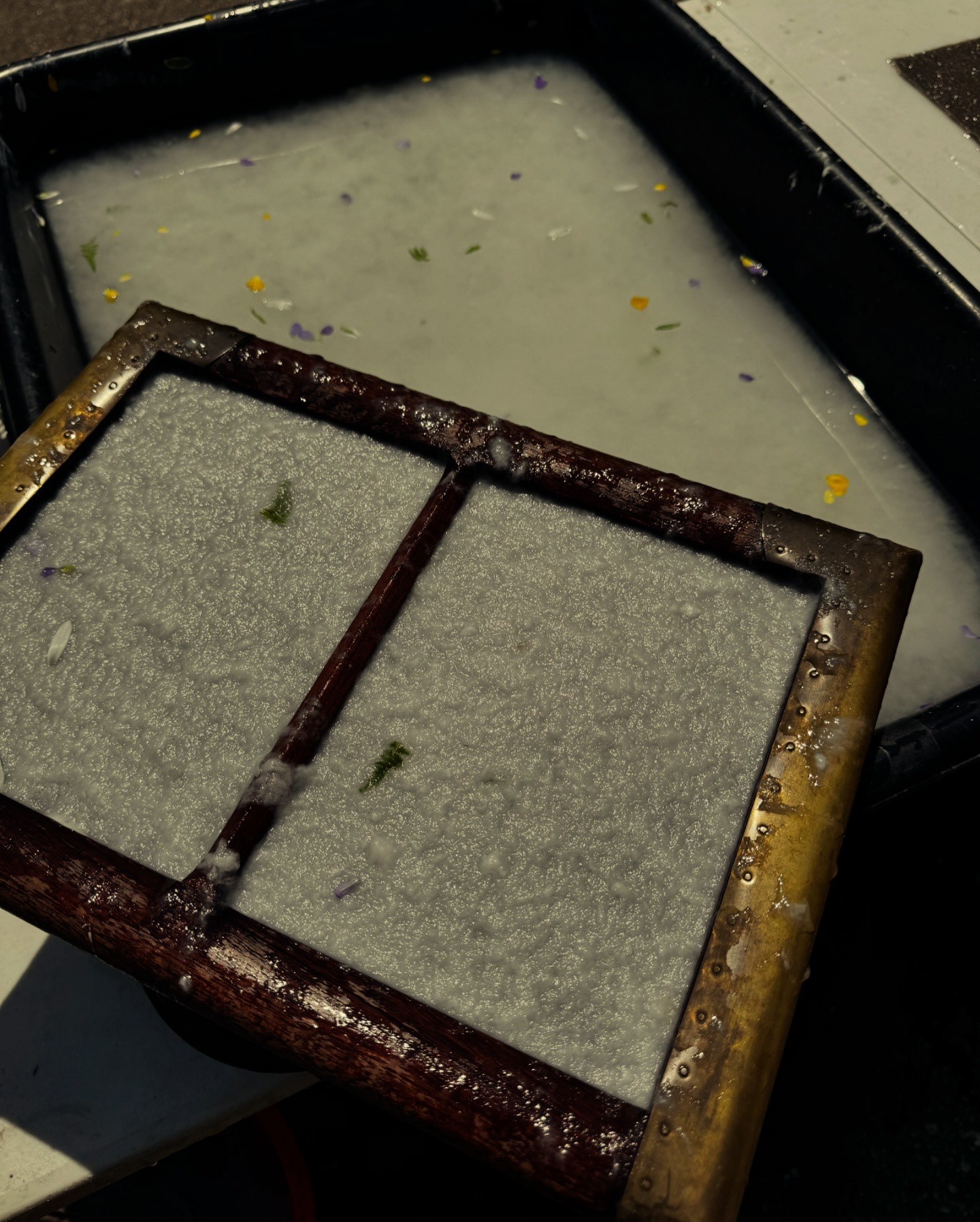 Custom mold and deckle used to create the small format paper.