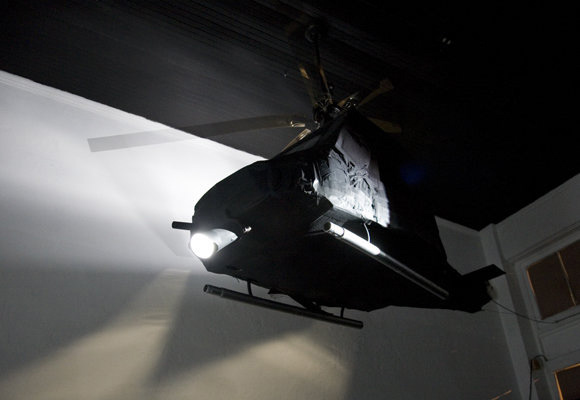 Cardboard police helicopter with video projector in empty storefront downtown Tucson, AZ. 