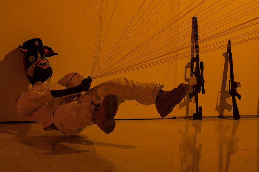A soldier is being lifted off the ground and he attempts to hold the entire fleet of Drone Target Kites