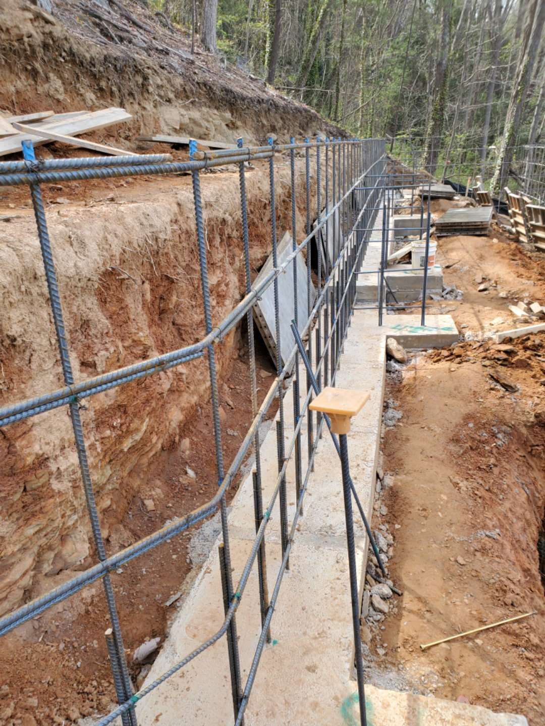 Wire tied rebar grids add significant structure to poured walls over block walls.