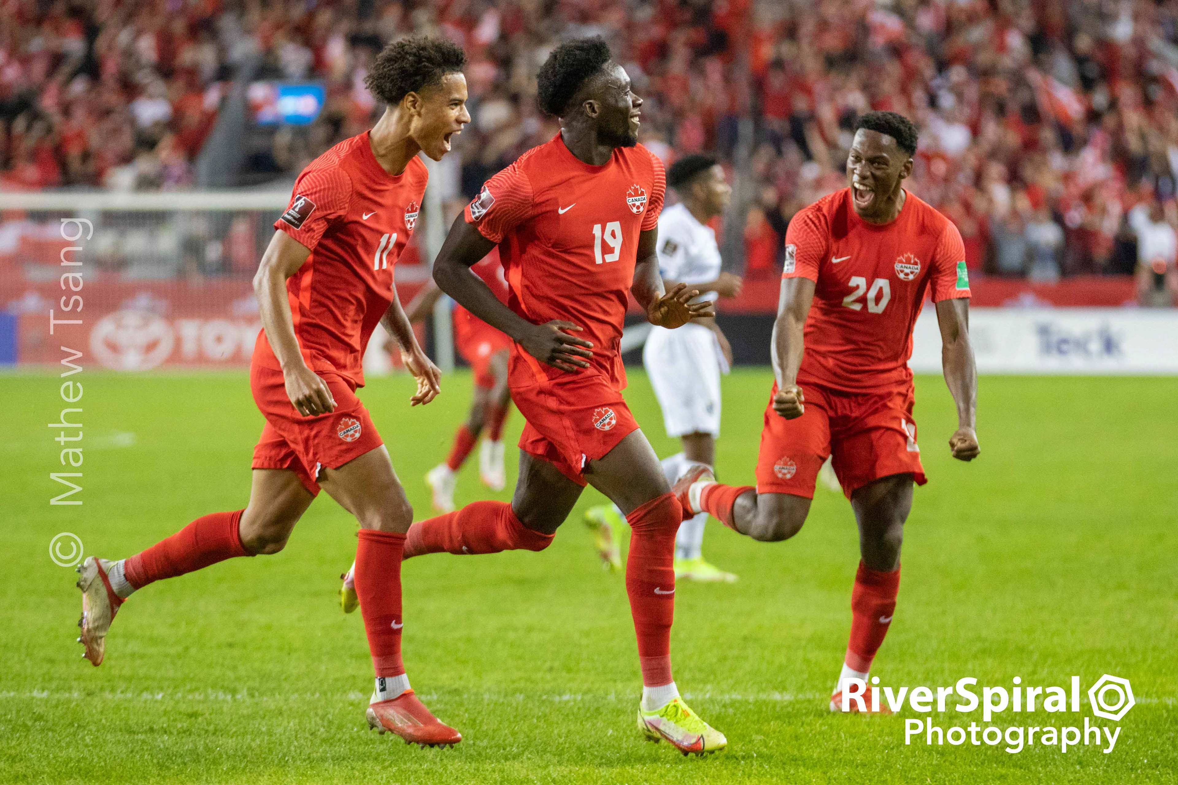 Team Canada Midfielder Alfonso Davies (19), center, celebrates his second half goal with teammates Jonathan David (20) and Tajon Buchanan (11). Canada defeated Panama 4-1 in the Final Round of FIFA World Cup 2022 Qualifiers on Wednesday, Oct 13, 2021