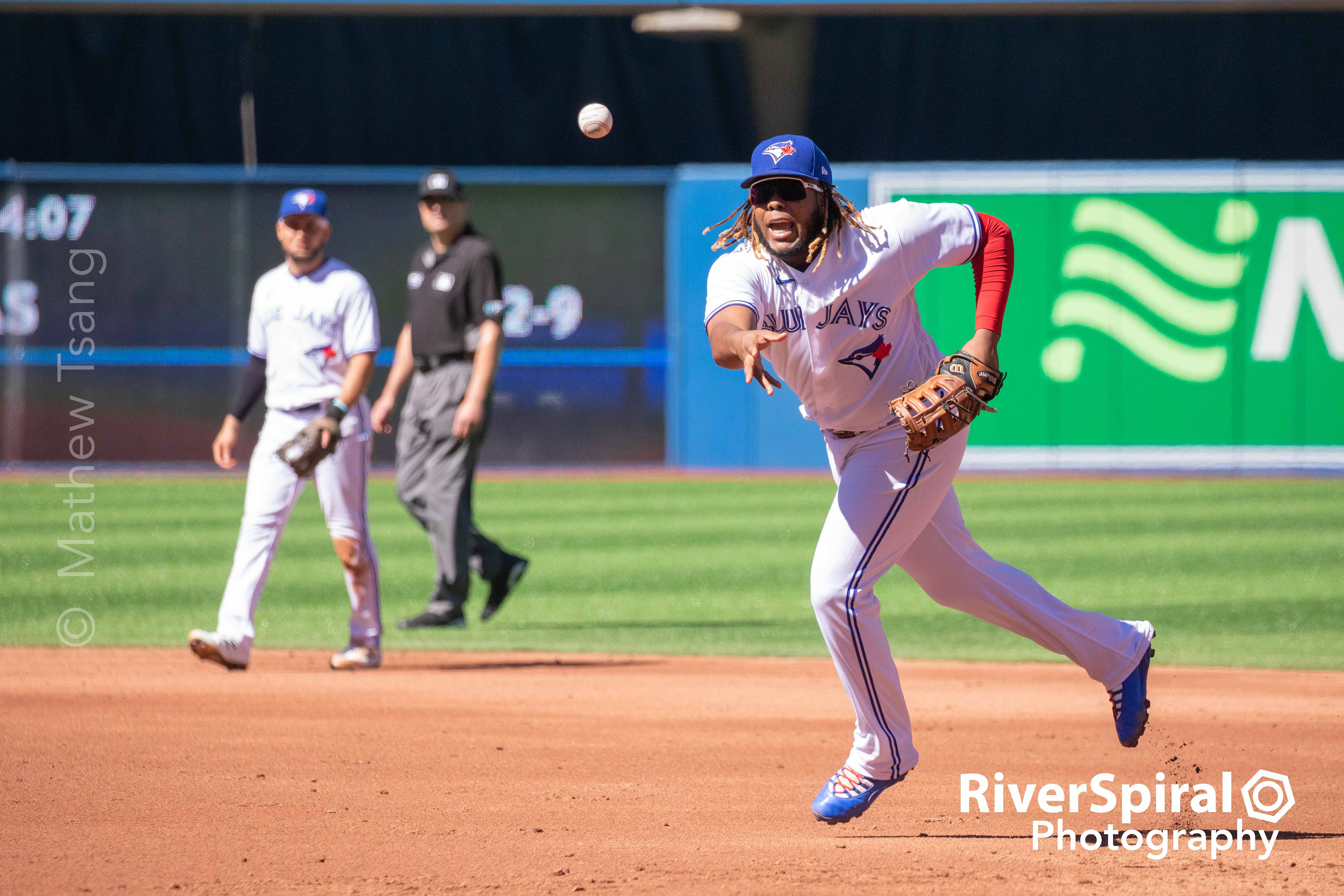 Vladimir Guerrero Jr. (27) tosses the ball to the pitcher.