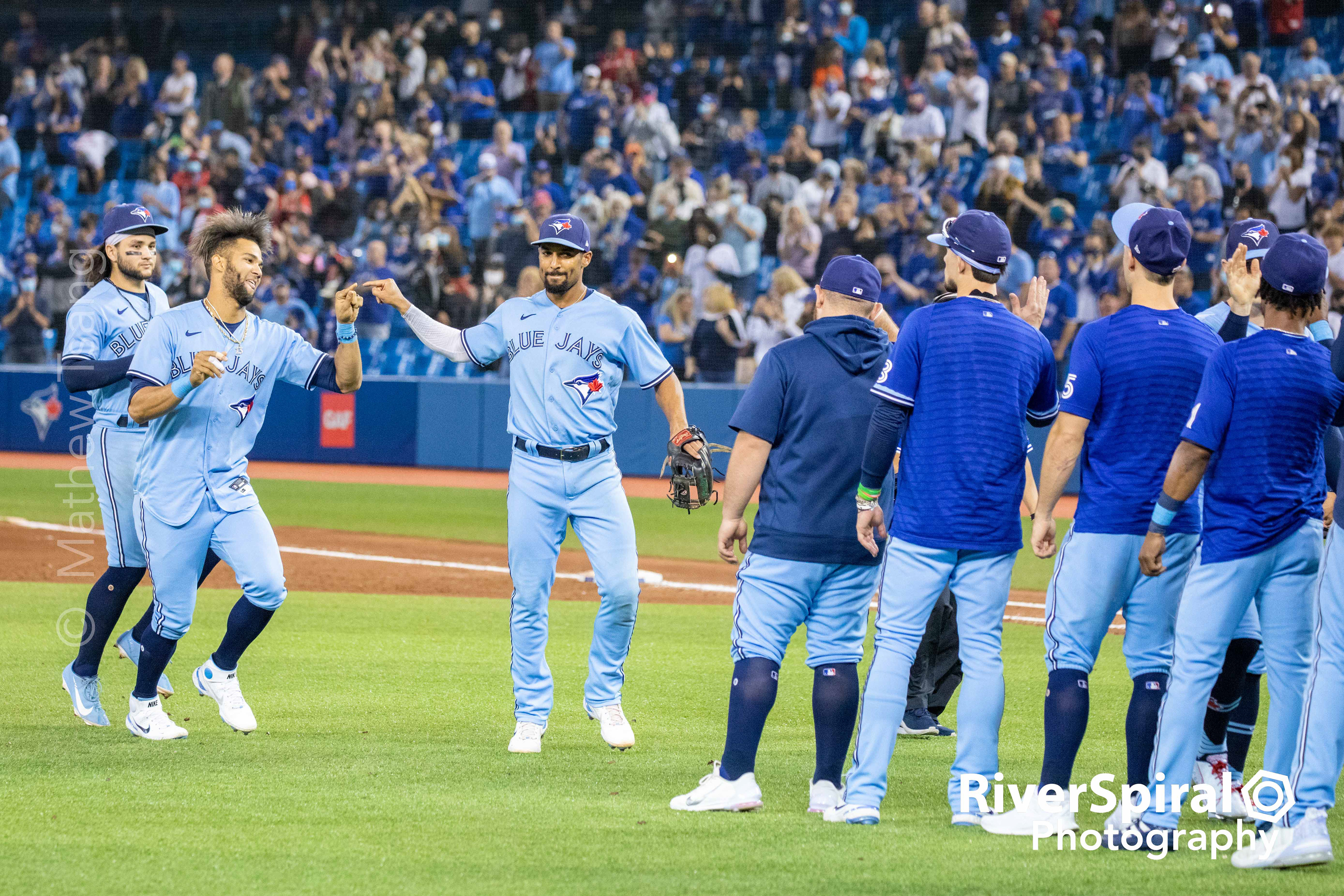 Lordes Gurriel Jr. and Marcus Semien touch fingers to celebrate a Blue Jays win.