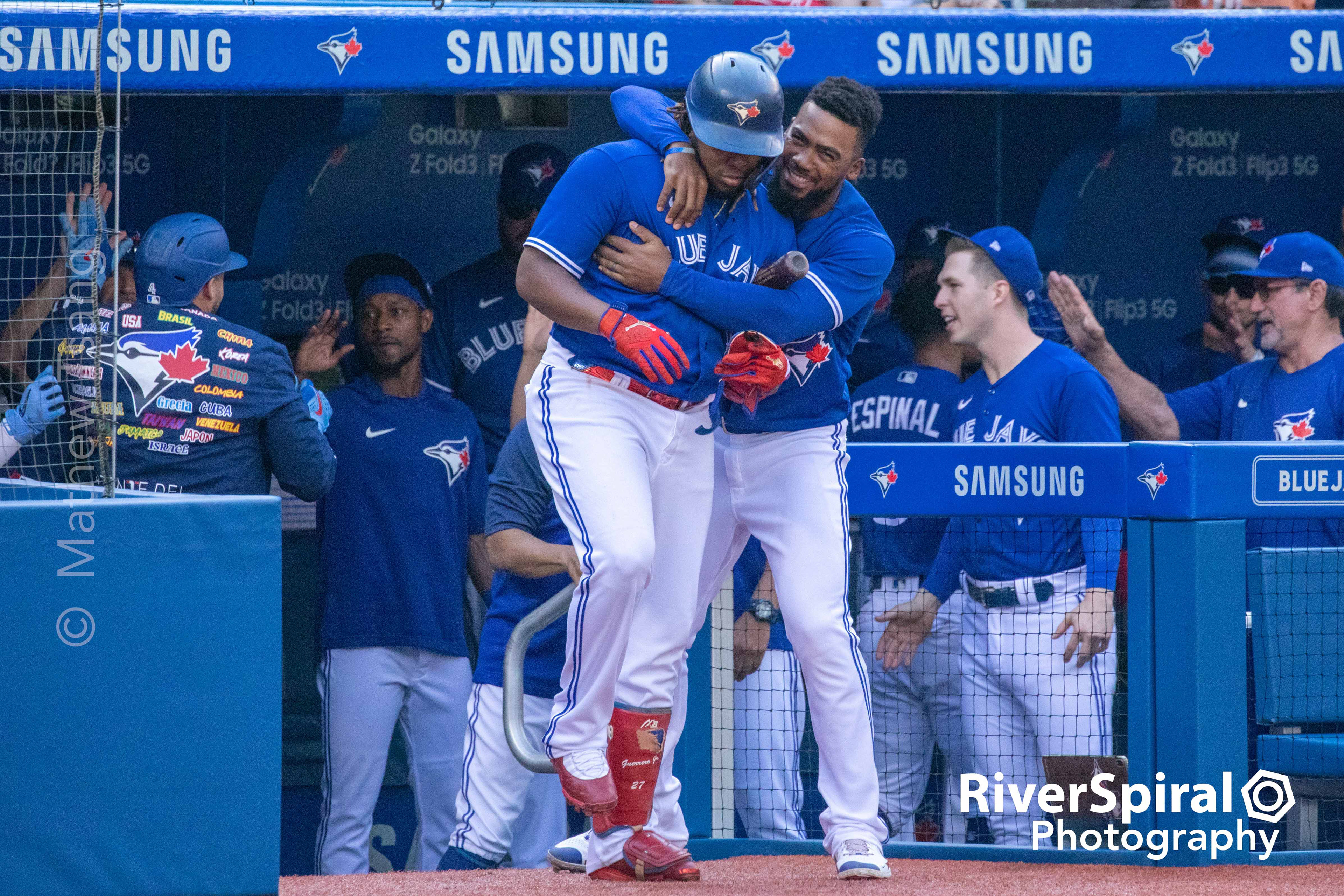 Vladimir Guerrero Jr. (27) and Teoscar Hernandez (37) celebrate at the team bench.
