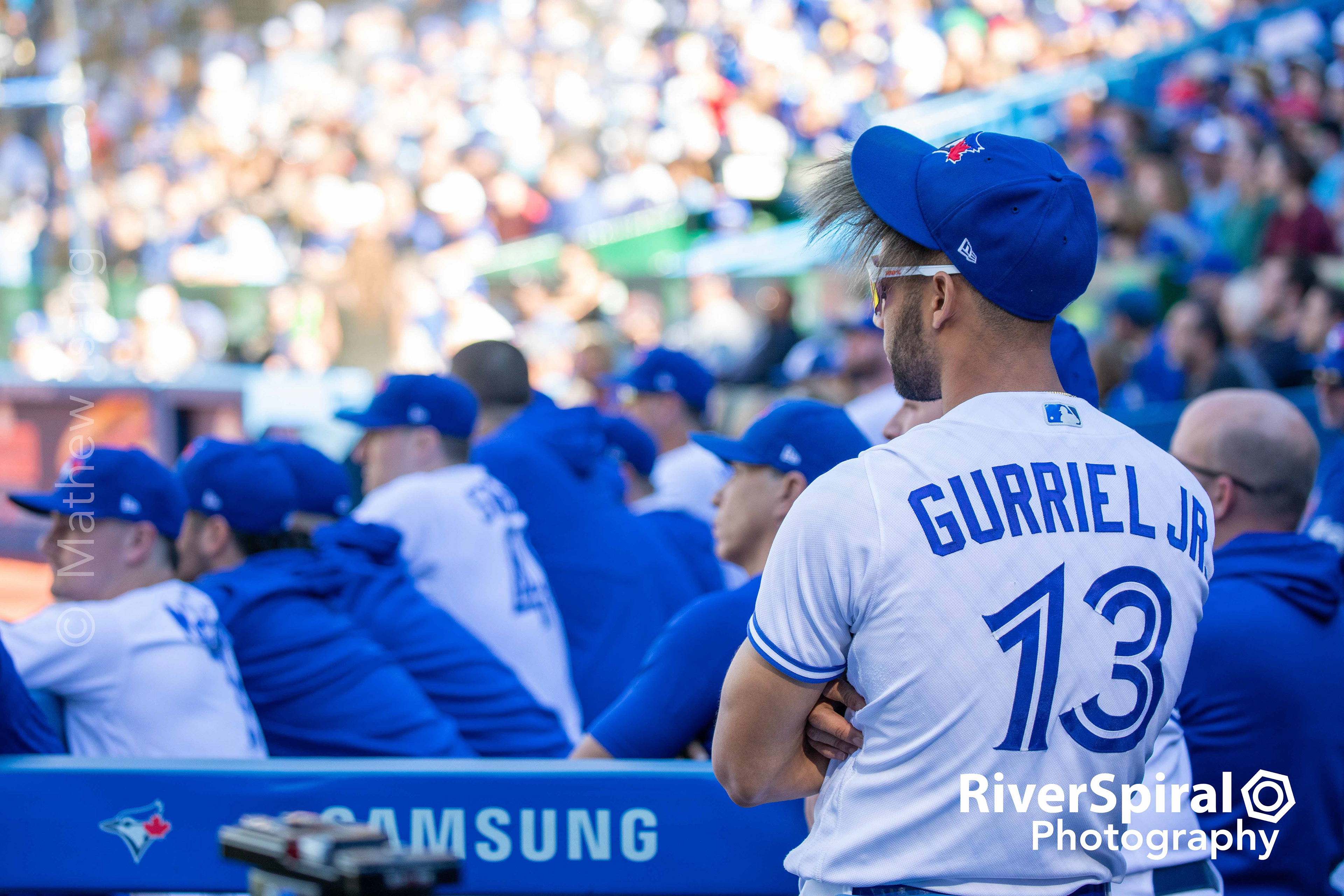 Lordes Gurriel Jr. (13) watches the action from the dugout.