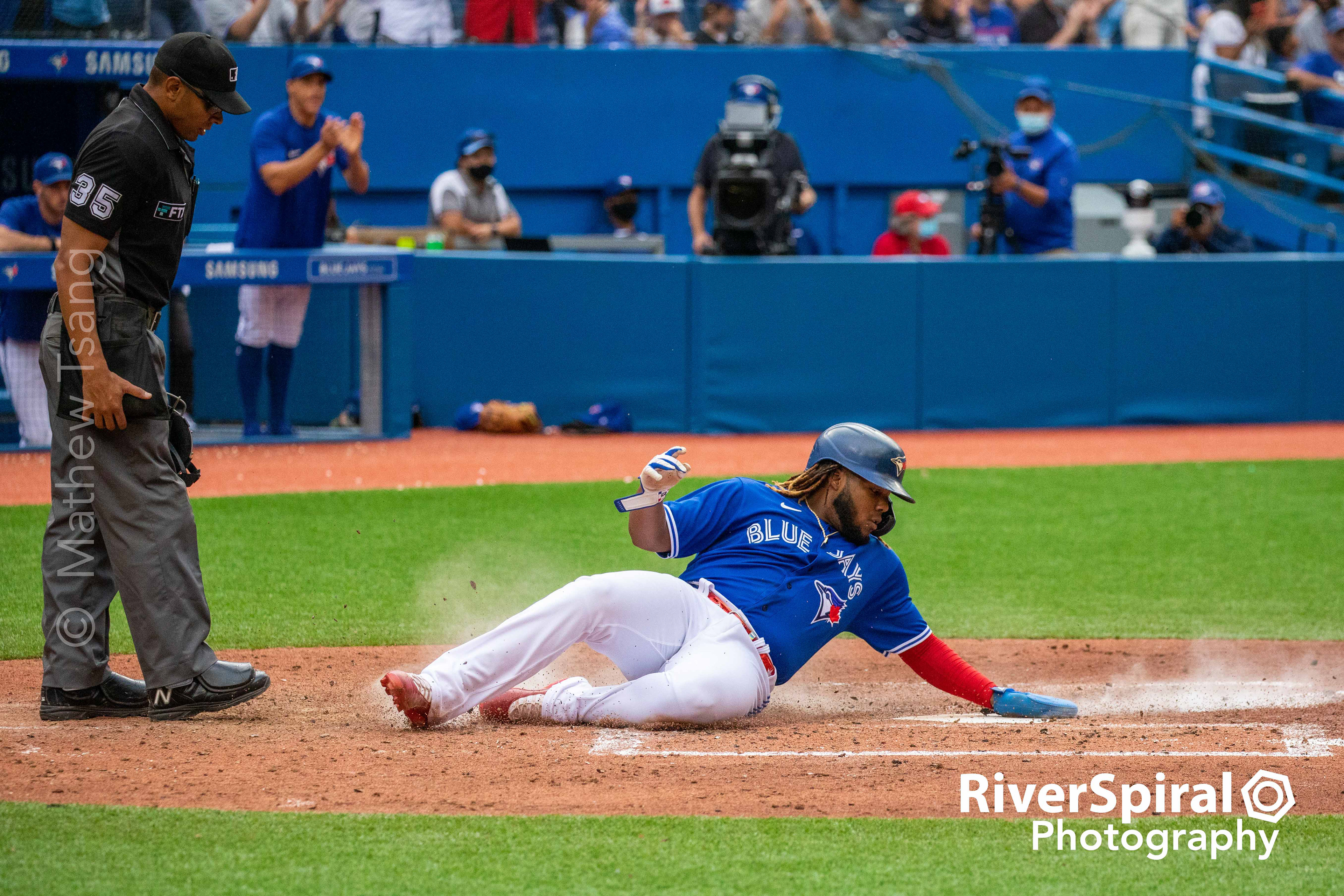 Vladimir Guerrero Jr. (27) slides into home.