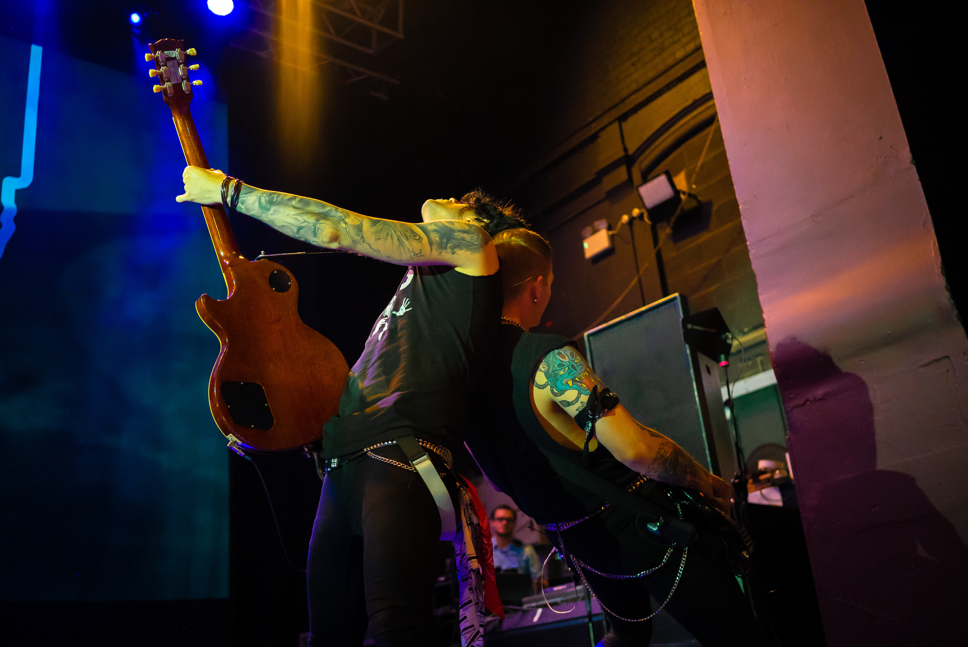 Guitarist and Bassist back to back whilst playing riffs