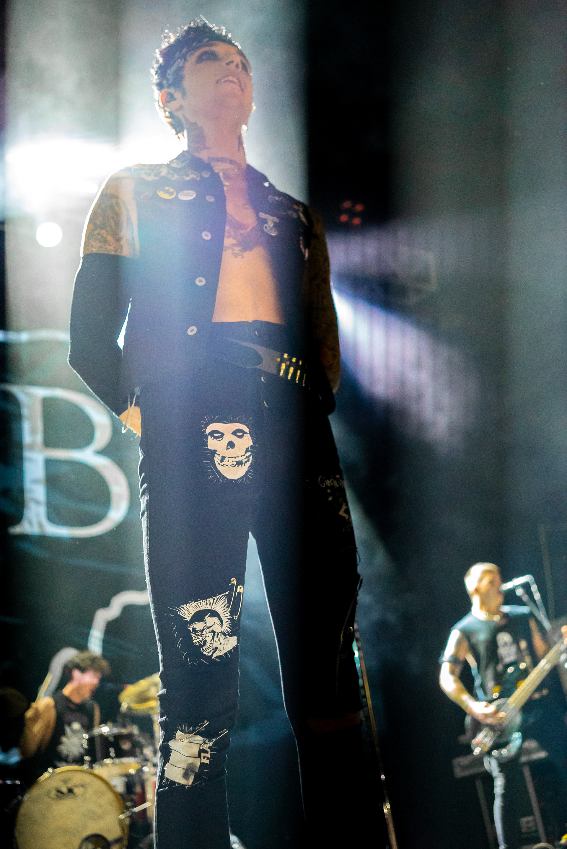 Andy Black observing the crowd as a white light shines upon him