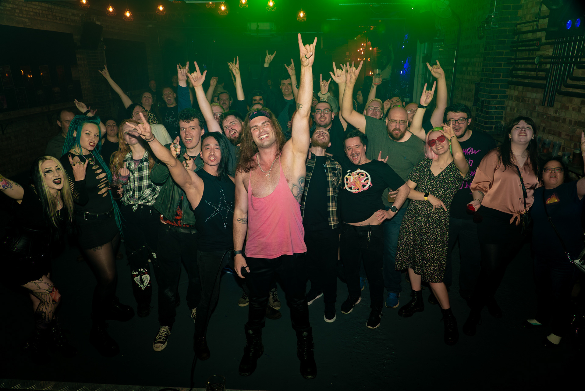 A venue full of people posing for a photo with popular DJ Jon Mahon.