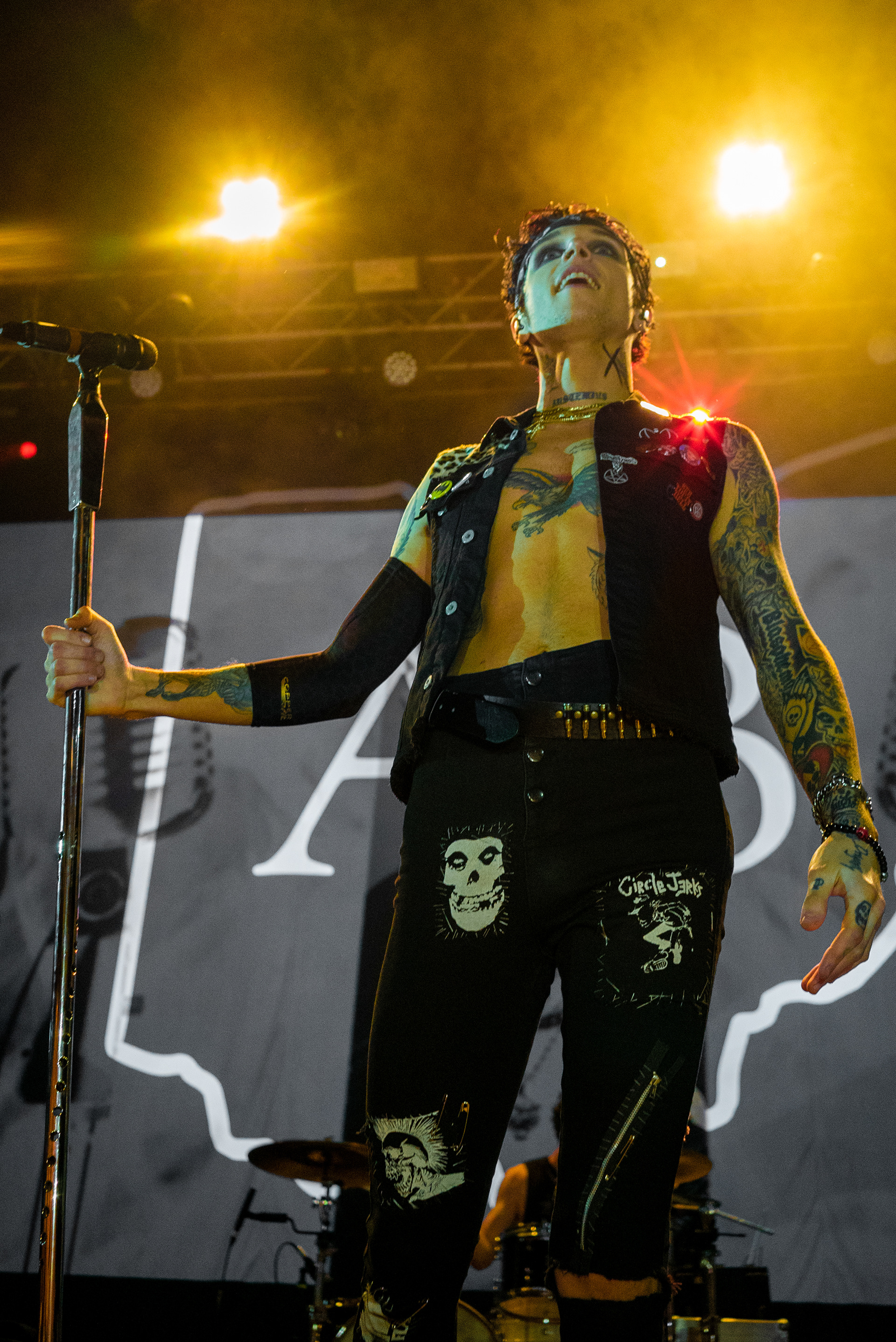 Andy Black holding his microphone stand and taking in the atmosphere by smiling at the crowd