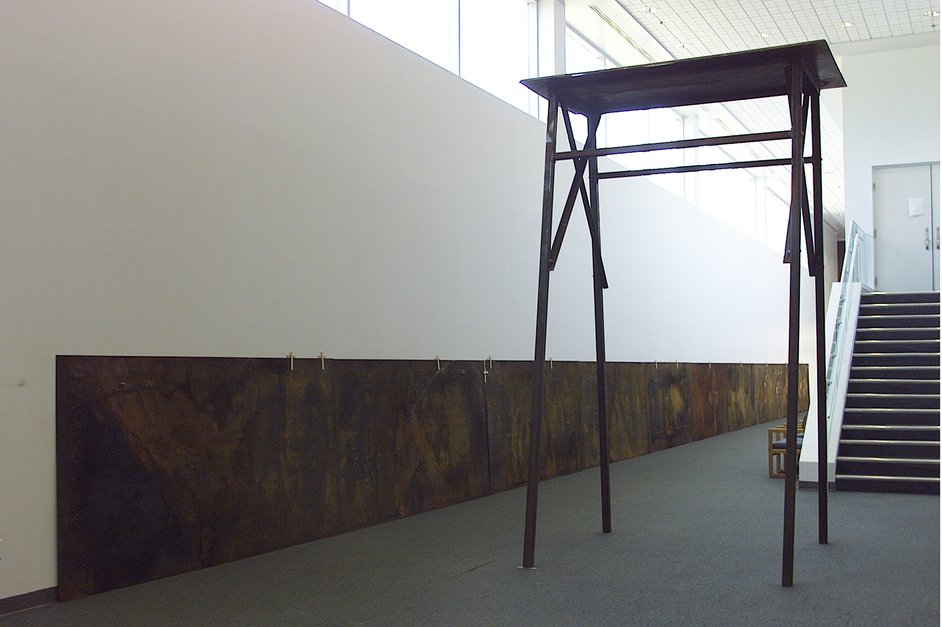Partial view from the exhibition "Misa negra". wood, metal. installation. variable dimensions