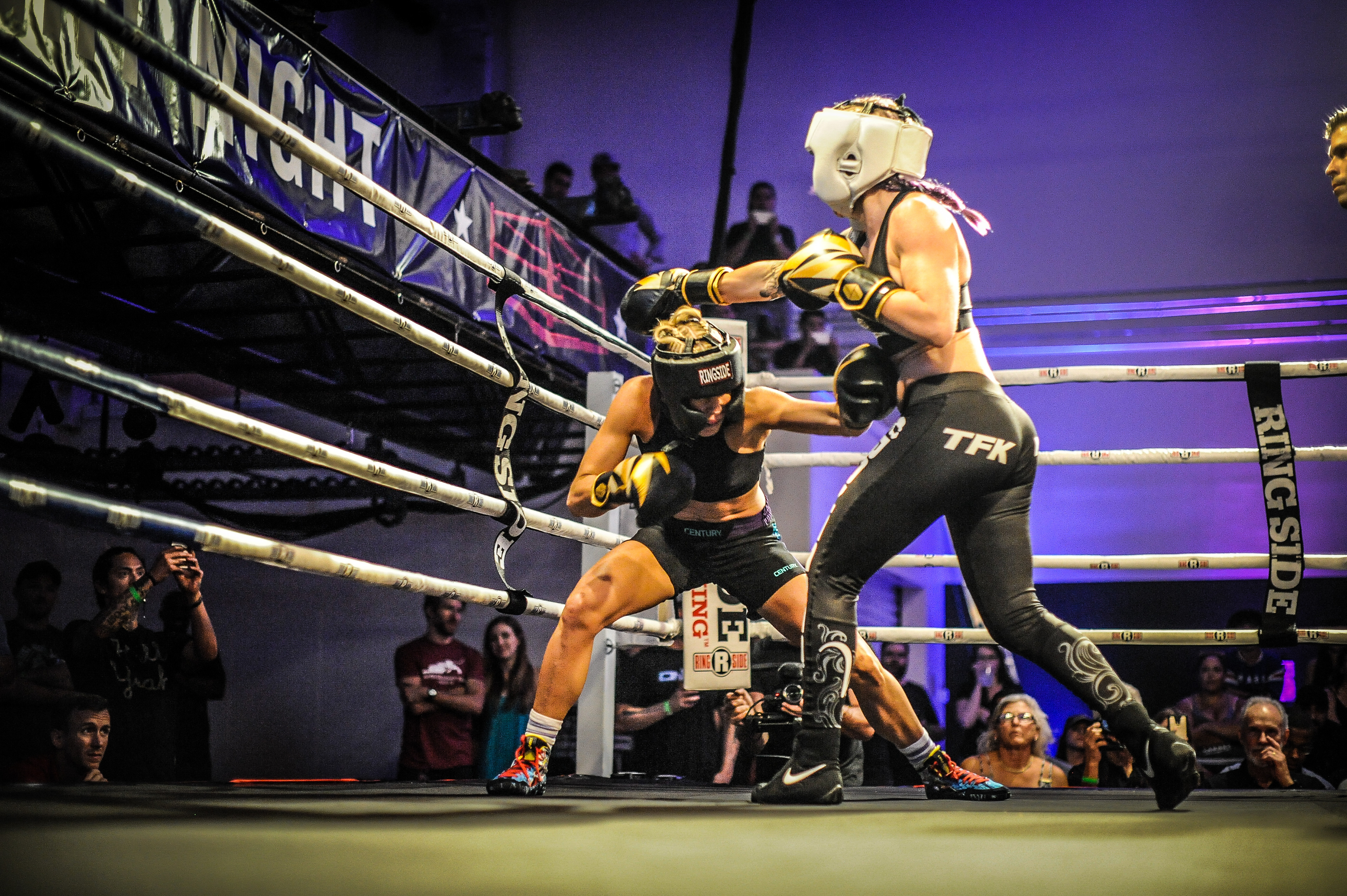 Two contenders. Sparring. Next to the giant banner.