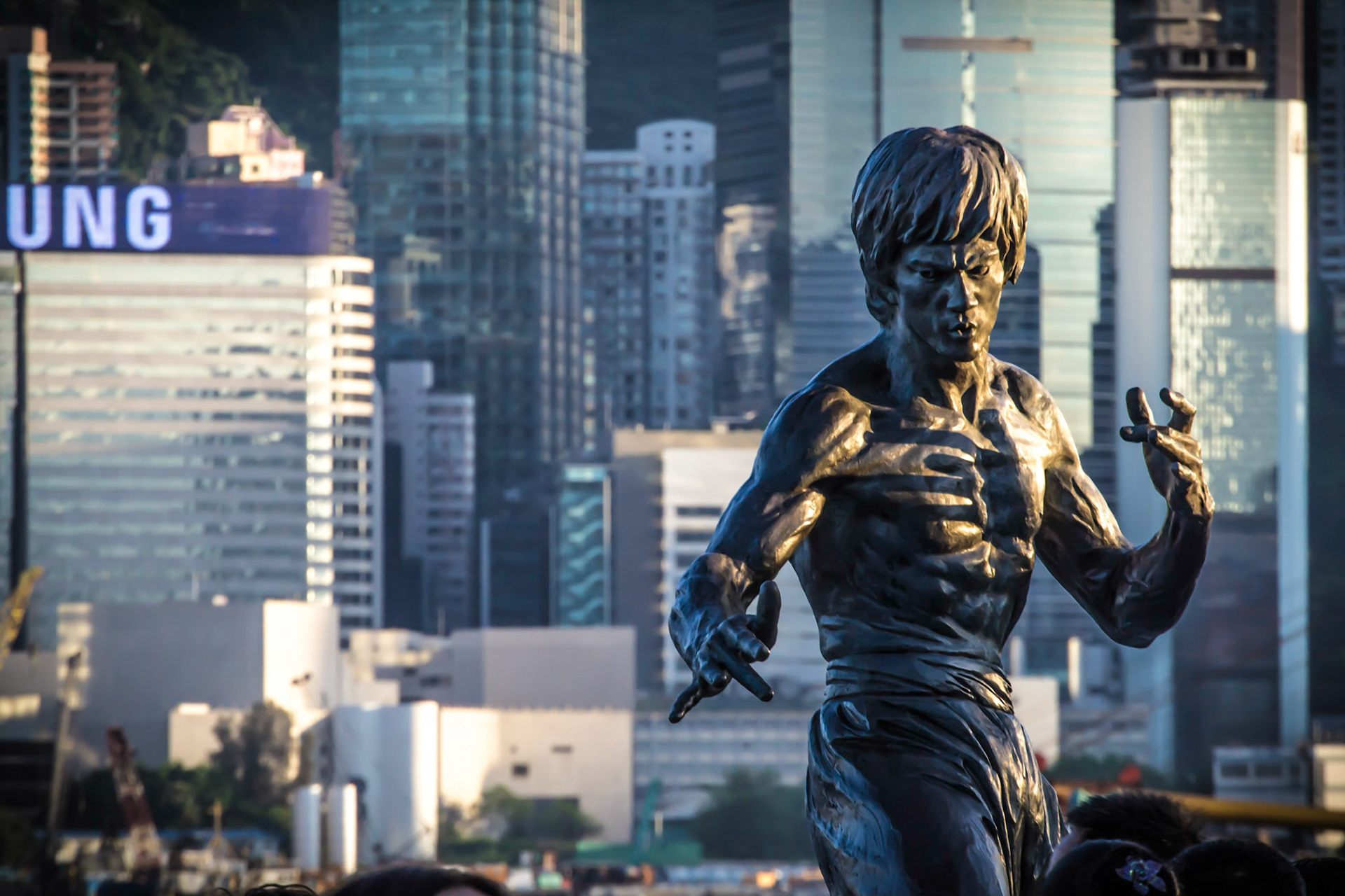 500px Photo ID: 78303889 - Bruce Lee sculpture at the Avenue of the Stars in Kowloon, Hong Kong. A view of Hong Kong Central district behind the sculpture