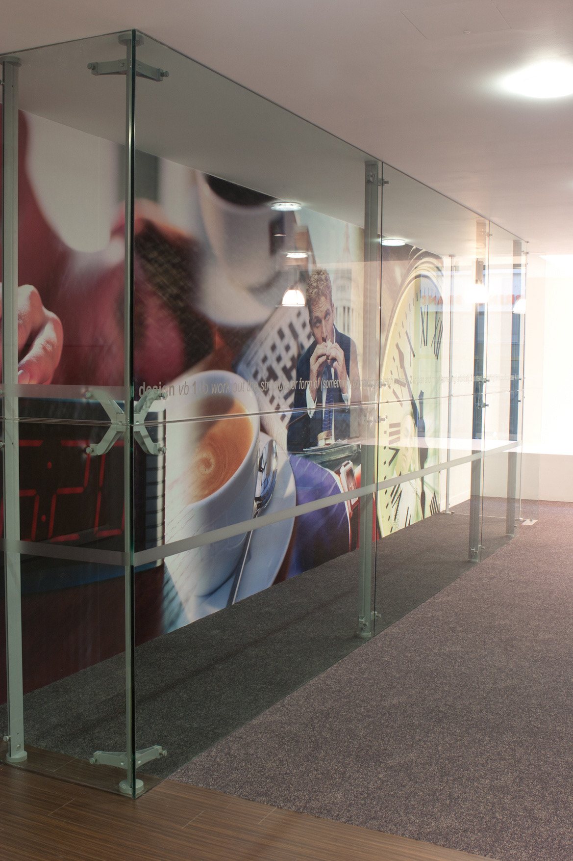 Structural glass wall with wall graphic behind