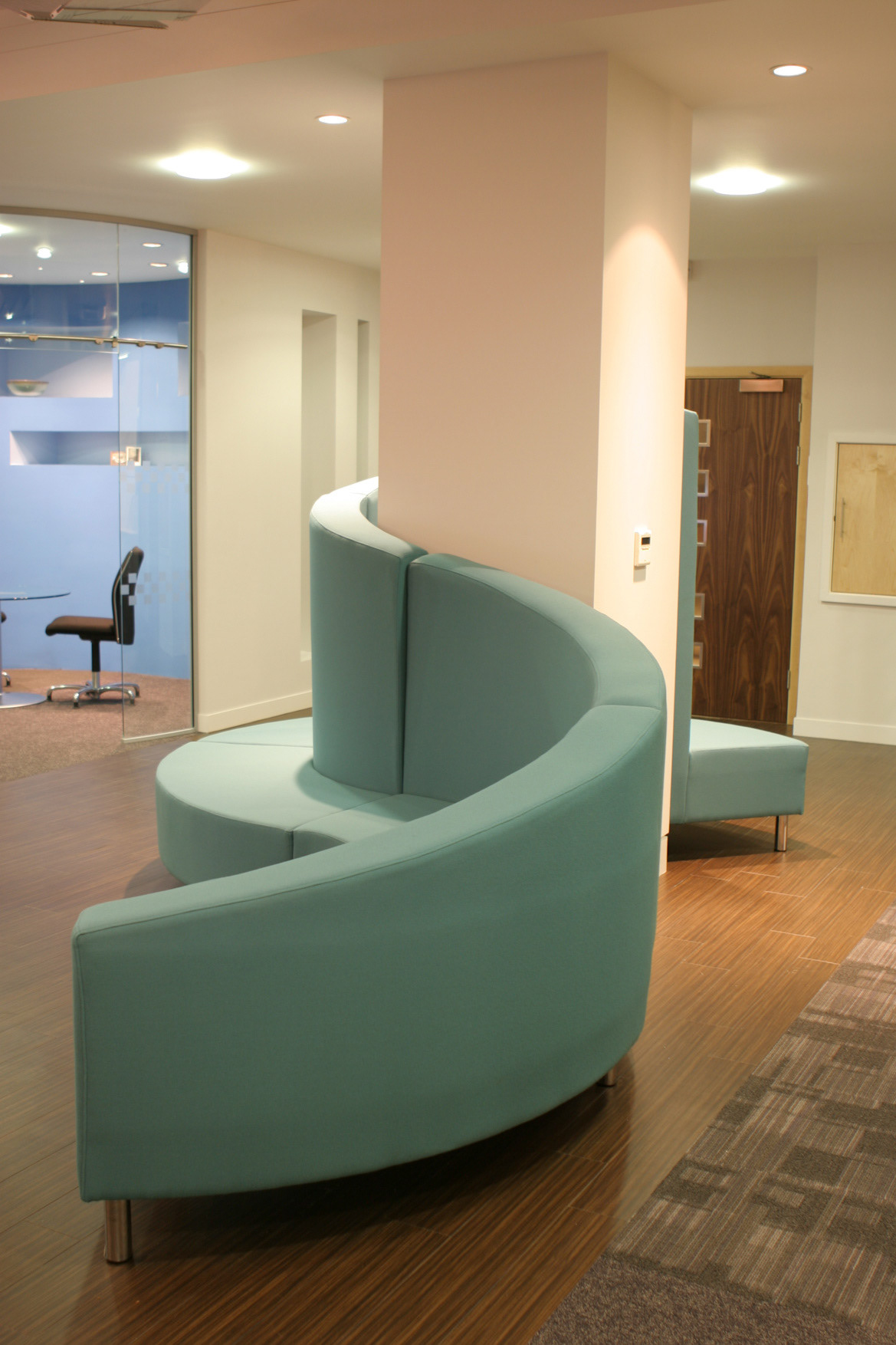 Bespoke designed sofa to wrap around the column
