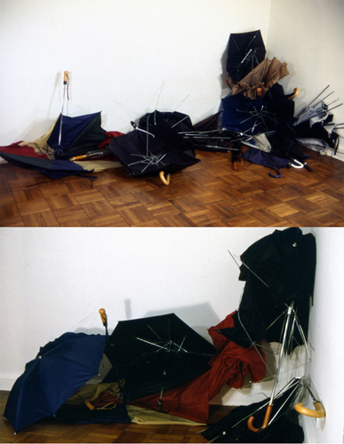 Protection/Aftermath 1999. umbrellas. varies with installation Used umbrellas in various degrees of disrepair are strewn on the floor and are accumulated on top of each other. The viewer feels as if having entered a disturbed, disorderly space much like after a heavy rainstorm or a cluttered and unkempt space.
