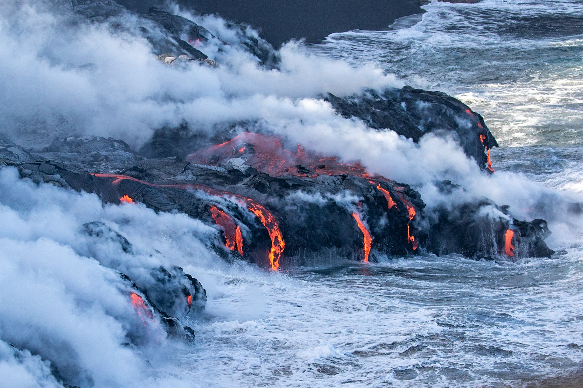 coulée de lave se jettant dans la mer fumeroles lava flow to the sea fumes
