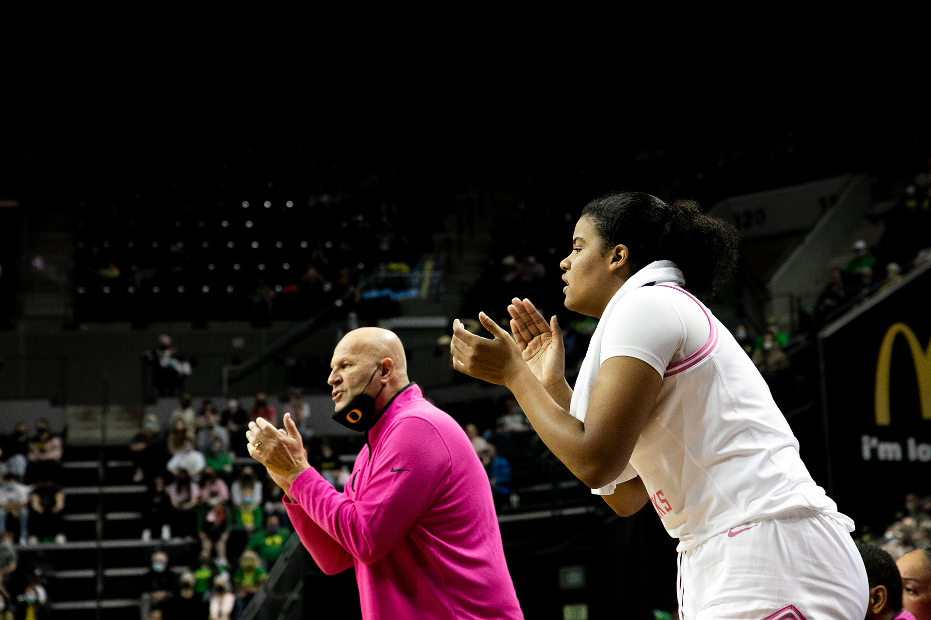 Nyara Sabally and Coach Graves encourage players from the bench.