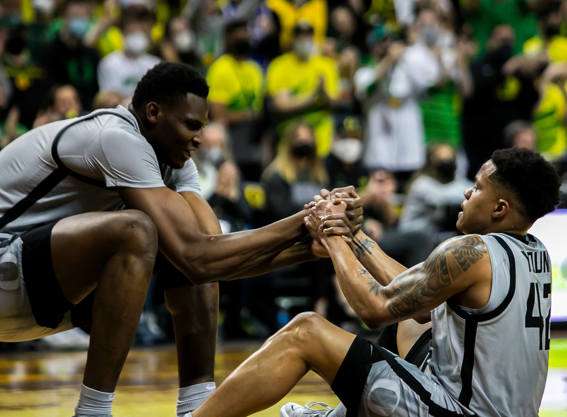 N’Faly Dante helps up teammate Jacob Young after a hard foul.