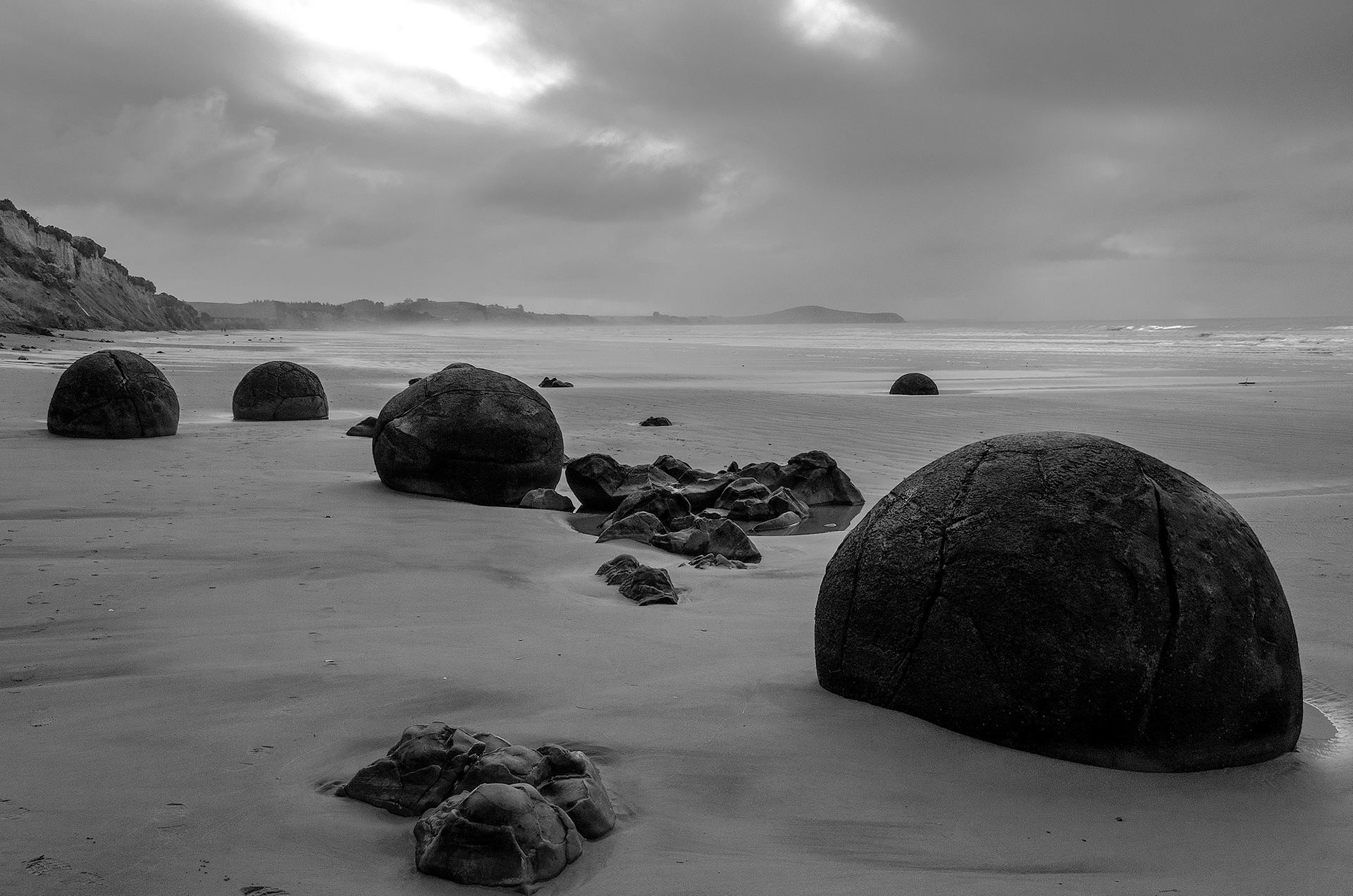 The Moeraki Boulders lying along a stretch of Koekohe Beach on the wave-cut Otago coast of the New Zealand South Island between Moeraki and Hampden